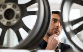 male customer choosing wheel rims at car service